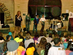 students on stage with a crowd doing a skit. 